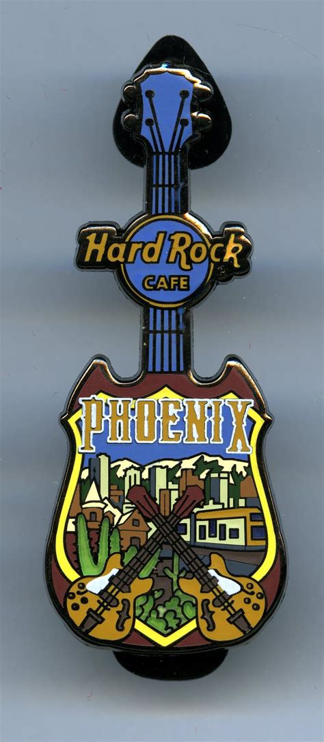 A Guitar Shaped Pin With The Words Hard Rock Cafe On It S Back Side