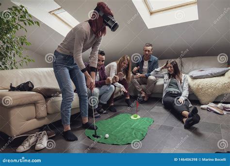 Group Of Young Adults Have Fun Playing Golf With Virtual Reality