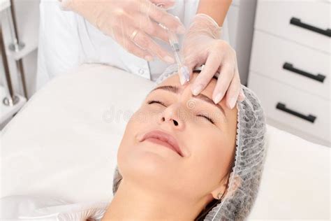 Cosmetologist Makes Rejuvenation Injection In Woman Face Anti Aging Procedure In Beauty Salon