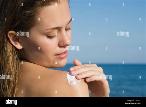 Woman Applying Sunscreen At The Beach Stock Photo Alamy