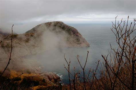 Photo Of Cliff Near The Sea Under Cloudy Sky · Free Stock Photo