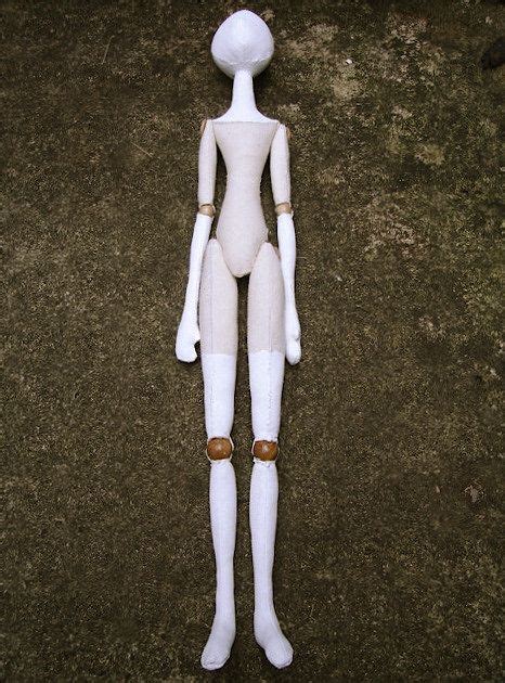 a white mannequin standing on the ground with its head turned to the side