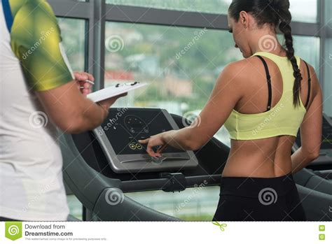 Personal Trainer And Client In Gym On Treadmills Stock Image Image Of