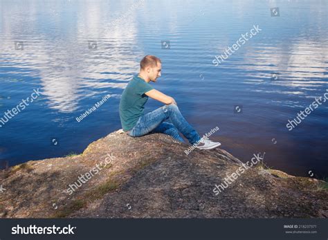 Sad Man Sitting On Rock By Stock Photo 218237371 Shutterstock