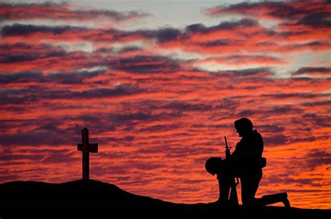 Soldier Kneeling At The Cross