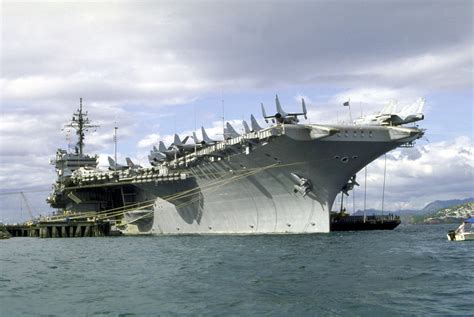 An Aircraft Carrier Is Docked In The Water