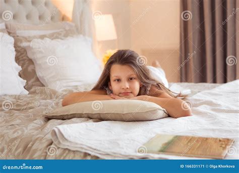 smiling girl laying on bed and looking at camera stock image image of home cute 166331171