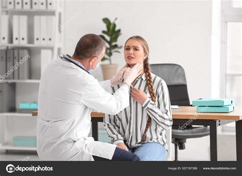 Doctor Examining Womans Neck Clinic Stock Photo By ©serezniy 557197386