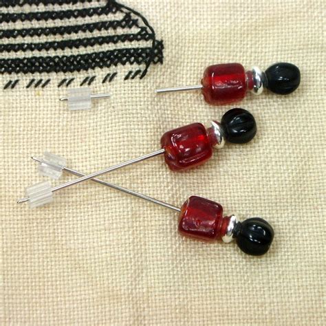 Small Red And Black Counting Pins For Cross Stitch And