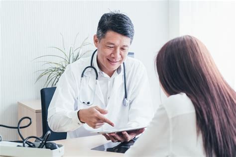 Premium Photo Asian Doctor And Patient Are Discussing