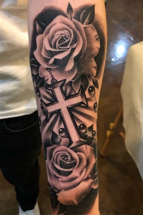 Rose tattoos are also often depicted with a butterfly, as a butterfly tattoo meaning traditionally represents beauty and femininity as well. Tattoo uploaded by Jae | Black & Grey Roses + Cross by Jae ...