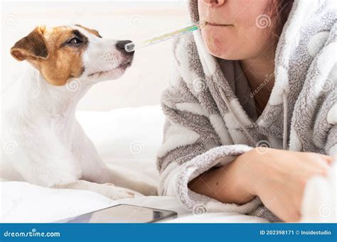 Caucasian Woman Lying In Bed And Measures The Temperature Orally Girl