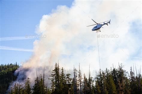 Helicopter Fighting Bc Forest Fires During A Hot Sunny Summer Day Stock