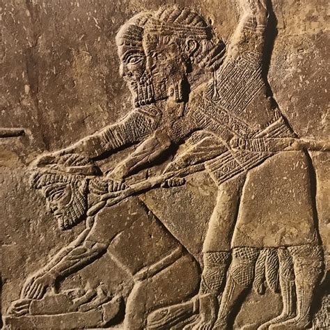 Two Assyrian Soldiers Forcing Babylonian Captive To Grind Bones Of His