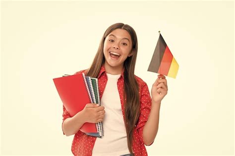 Premium Photo Surprised Child Hold German Flag And School Copybook