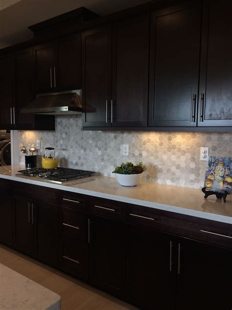 Dark kitchen cabinets are stunning, and picking the right countertop color to pair with your dark cabinets can make all the difference on your kitchen's style. Dark Brown Kitchen Cabinets, Light Quartz Countertop ...