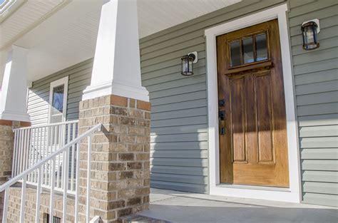 Beautiful Front Porch On This Craftsman Style Home With Brick Columns