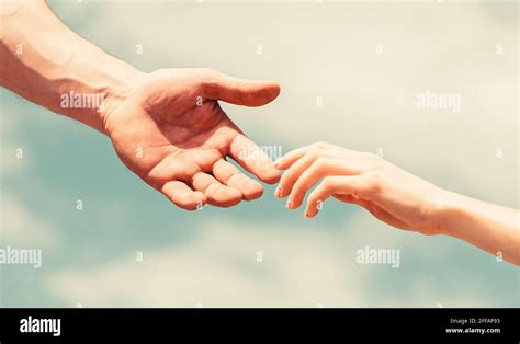 Hands Of Man And Woman Reaching To Each Other Support Giving A