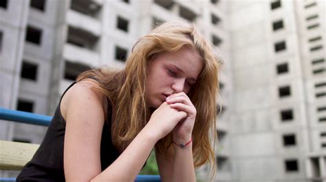 Nervous Girl Is Sitting Near High Building Stock Video Footage 0013