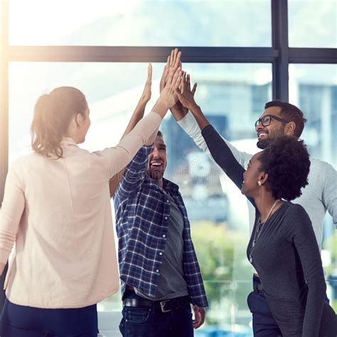 Go Team A Group Of People High Fiving In The Office Stock Image