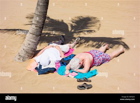 Mature Couple Sunbathing On Beach Hi Res Stock Photography And Images