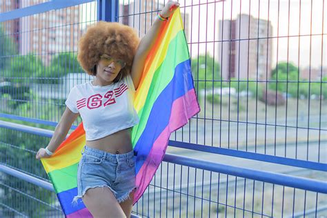 proud woman showing her gay pride flag on a bridge photograph by cavan images fine art america