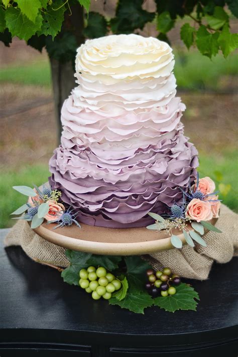 The ombre rose three tier wedding cake is covered in hundreds of sugar roses with a dramatic ombre effect. A stunning fall wedding cake featuring fondant ruffles and ...
