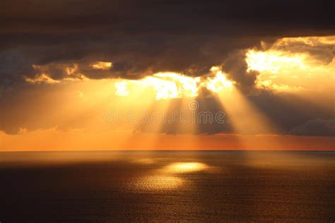 Sunbeams Through Dark Clouds Over Ocean Stock Photo Image Of