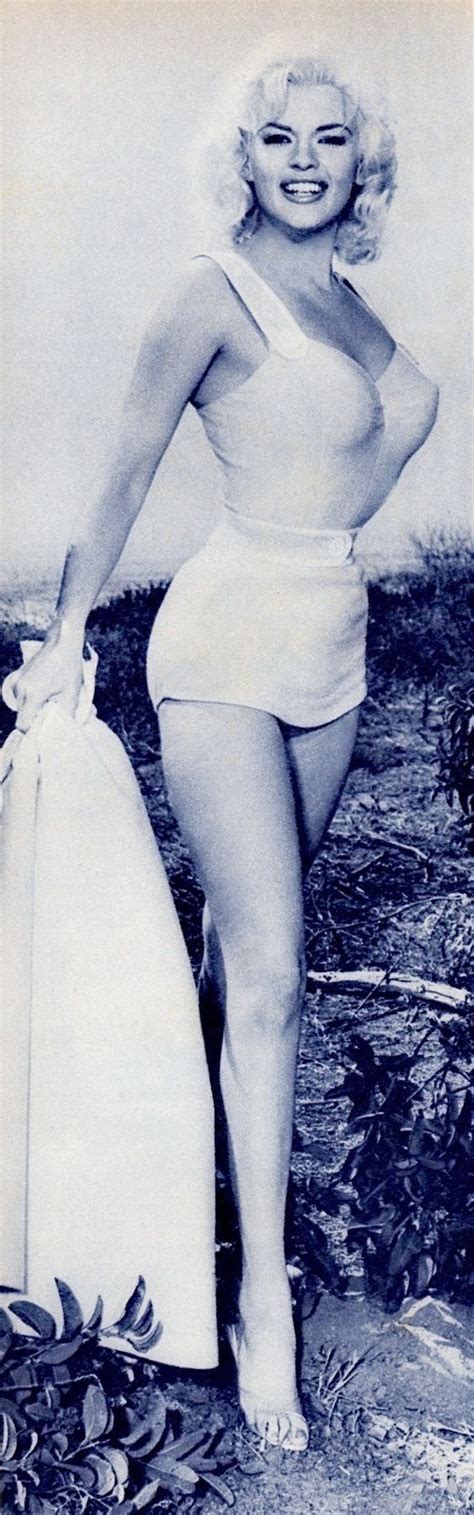 A Woman In A Bathing Suit Holding A Surfboard