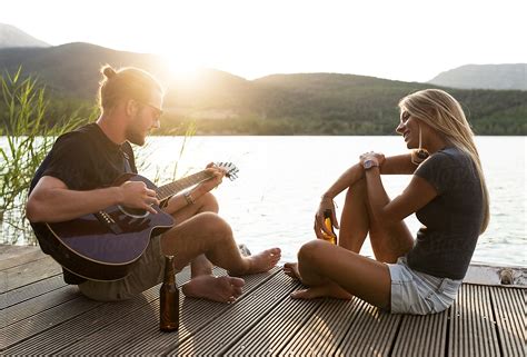 Couple Chilling On Pier By Stocksy Contributor Guille Faingold Stocksy