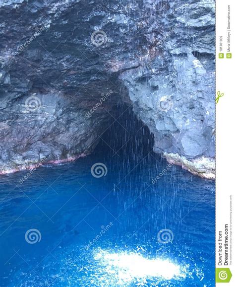 Cave And Waterfall In Napali Coast Mountains And Cliffs Seen From