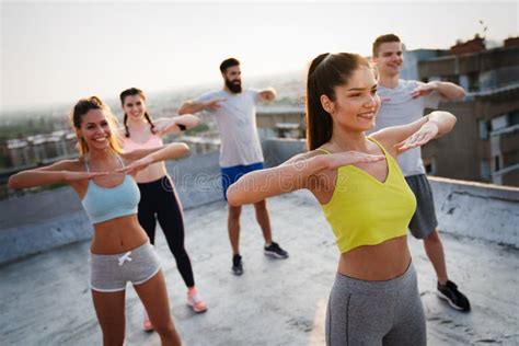Group Of Happy Fit People Friends Exercising Together Outdoor Stock