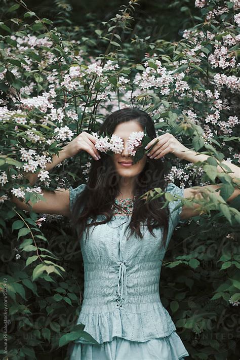 Beautiful Young Woman Hiding Her Eyes With Flowers By Jovana Rikalo Stocksy United