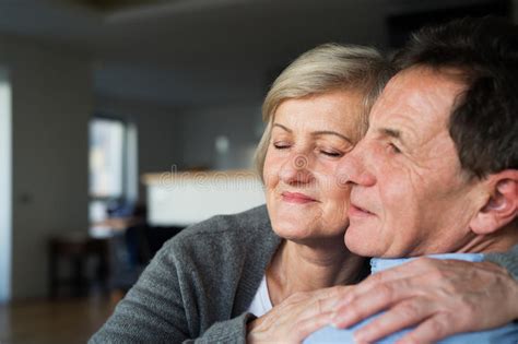 Senior Couple In Love In Their Living Room Hugging Stock Photo Image