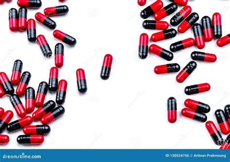 Red Black Antibiotic Capsule Pills Spread Out Of White Plastic Drug