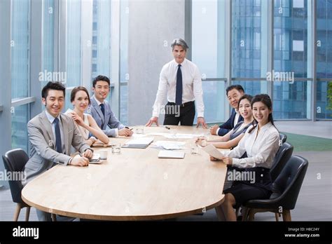 Chinese Business People Having Meeting In Board Room Stock Photo Alamy