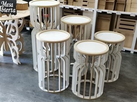 Several Tables And Stools Are On Display In A Store