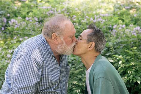 Senior Gay Couple Kissing In A Park By Stocksy Contributor Joselito Briones Stocksy