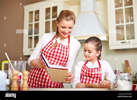 Smiling Mother Teaching Her Daughter To Cook Stock Photo Alamy