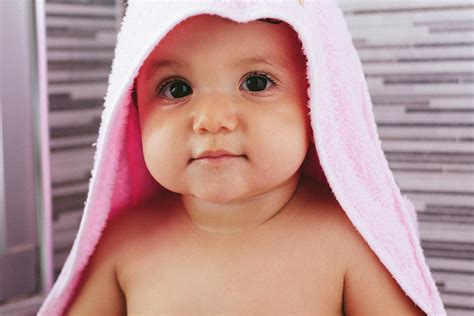 Baby Fresh Out Of The Shower With Pink Towel Photograph By Cavan Images