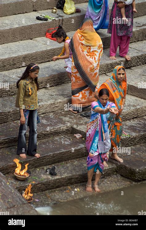 Nepalese Hindu Women Performing Ritual In The The Bagmati River At Pashupatinath Kathmandu
