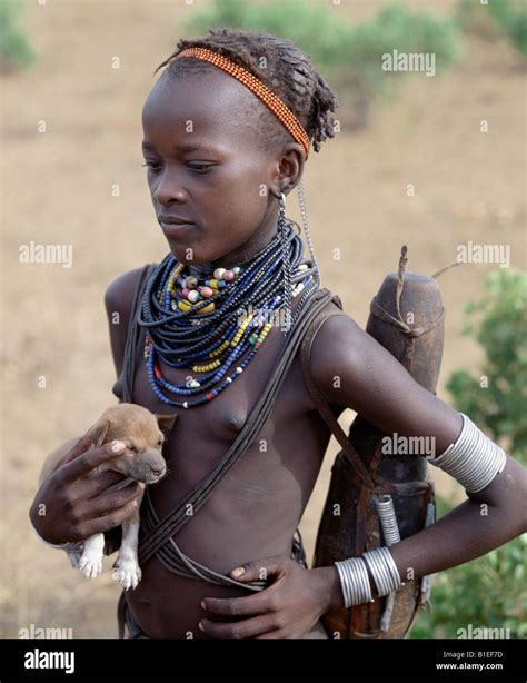 An Attractive Dassanech Girl Holds A Puppy Her Adornment Is Typical Of