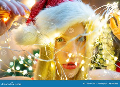 Smiling Christmas Girl With Red Lips Christmas Light Girl Is Wearing Santa Hat Concept Of
