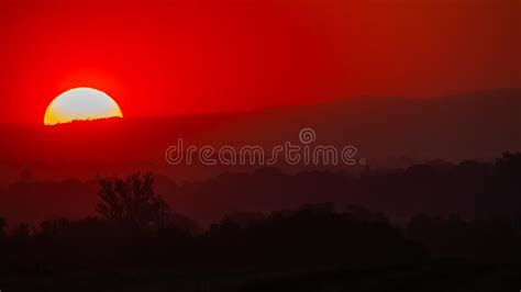 A Bloody Sunset Over The Fields Stock Photo Image Of Dramatic