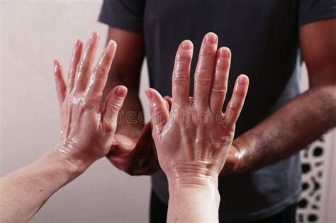 oil on the hands of massage therapists preparation for massage massage in four hands hands