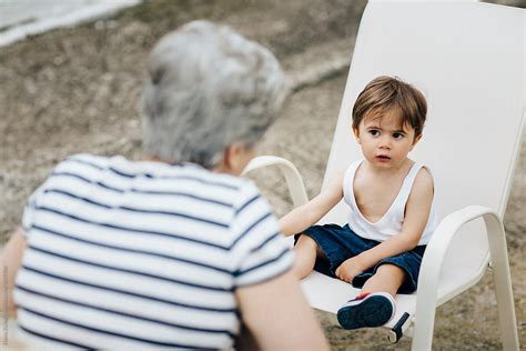 grandmother talking to her grandson by stocksy contributor nasos zovoilis stocksy