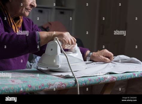 Older Lady Ironing Laundry Stock Photo Alamy