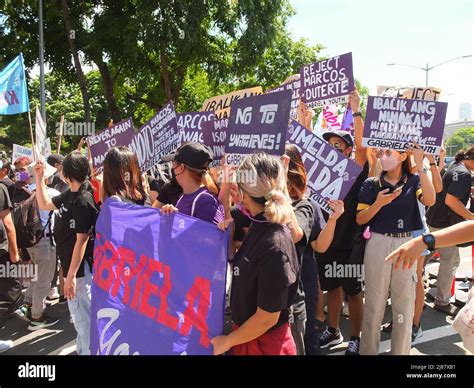 gabriela women s group organization hold a banner and placards expressing their during the