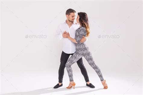social dance bachata kizomba zouk tango concept man hugs woman while dancing over white