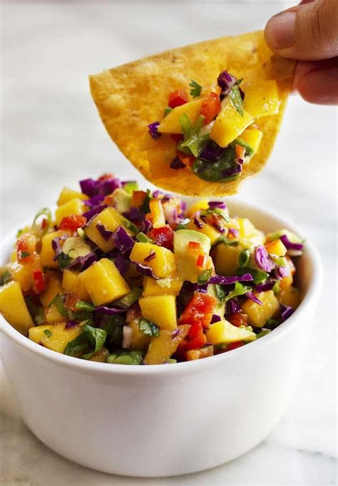 Peel and chop mango, avocado, onion, and cilantro. The best Mango Salsa recipe! So easy and made with fresh ...